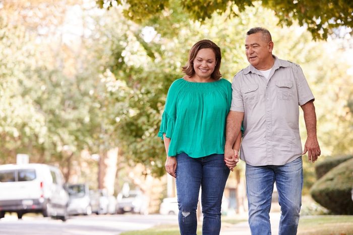 A couple walking holding hands