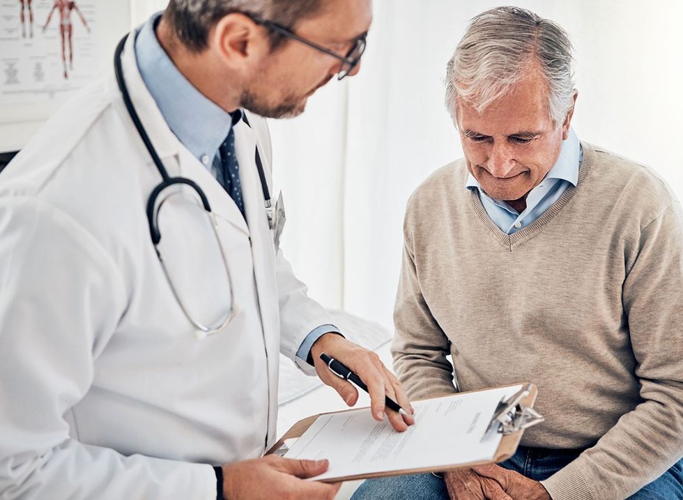 A doctor advises his senior patient 