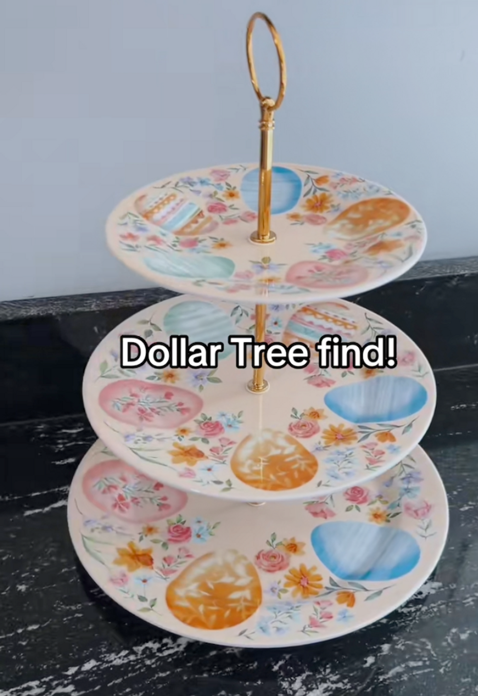 A three-tier serving plate from Dollar Tree with Easter eggs on it