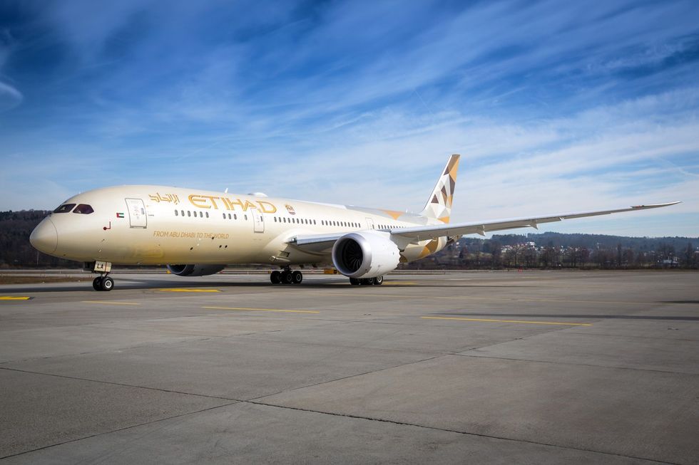 An Etihad Airways jet sitting on a runway