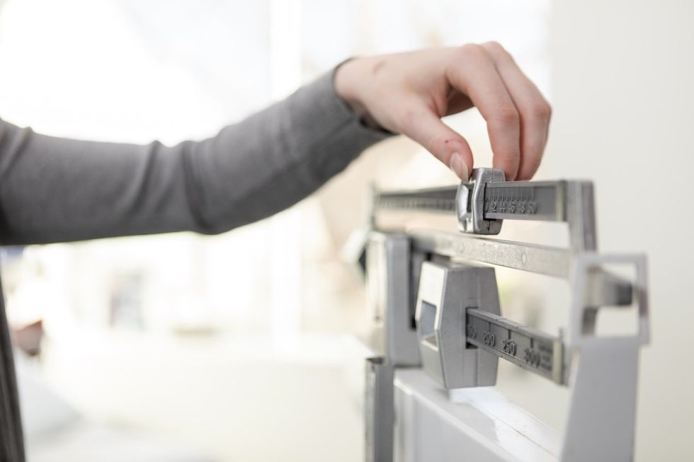 closeup of a woman adjusting a scale