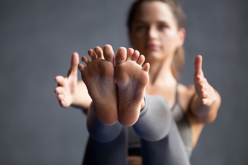 closeup of a woman doing a Pilates teaser