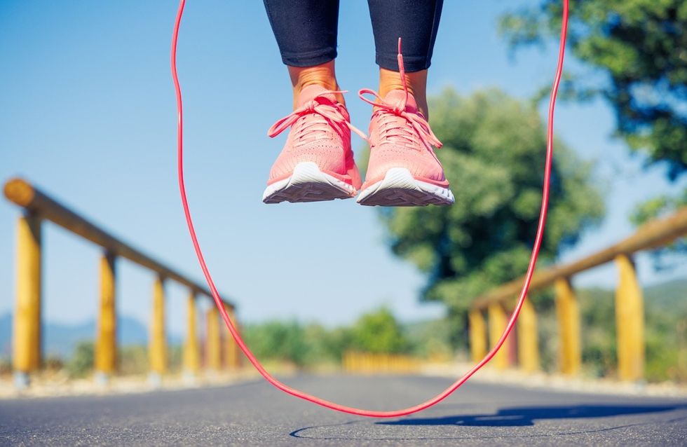 closeup of a woman's feet while jumping rope outside