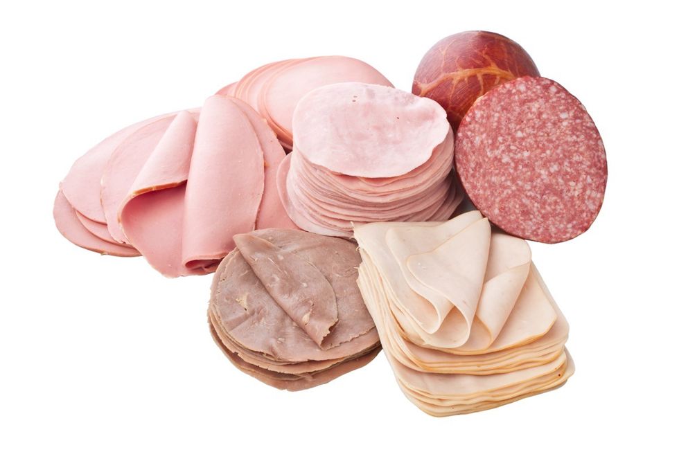 collection of cold cuts and sliced meats over a white background