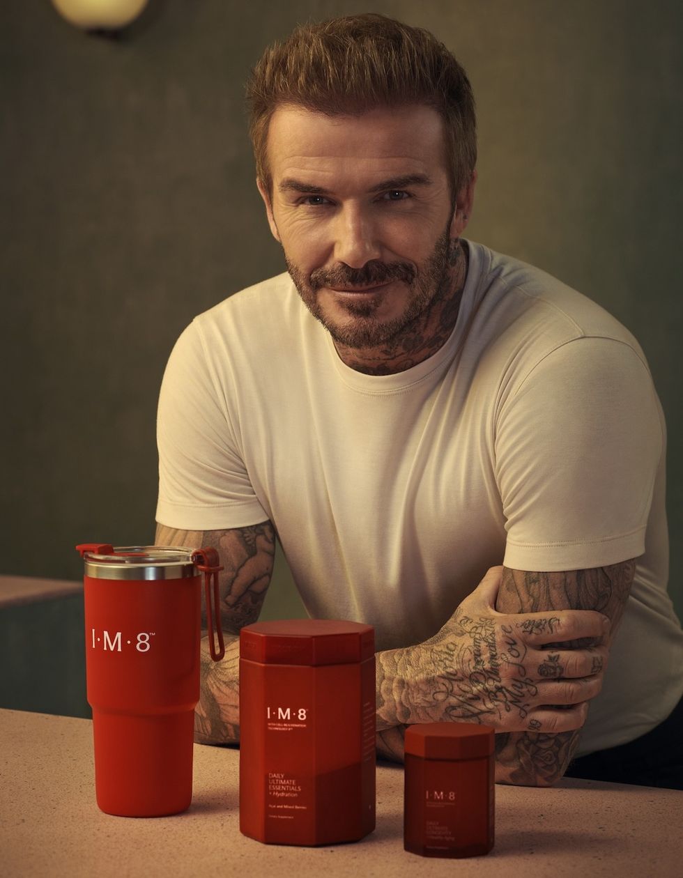 David Beckham poses with products from his supplement line, IM8 Health