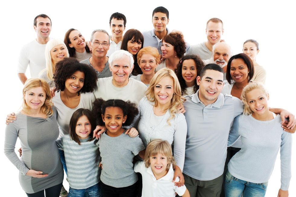 Group of people of all ages, races, and genders posing for photo