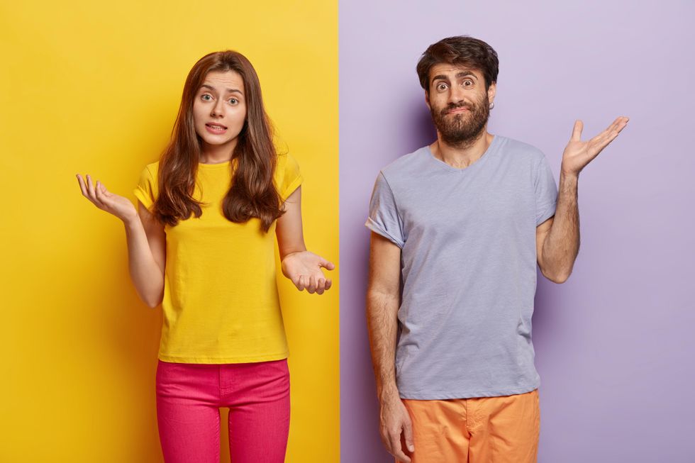 man and woman shrugging their shoulders and looking confused