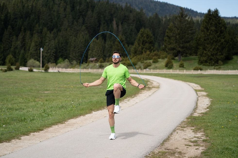 man outside skipping and jumping rope