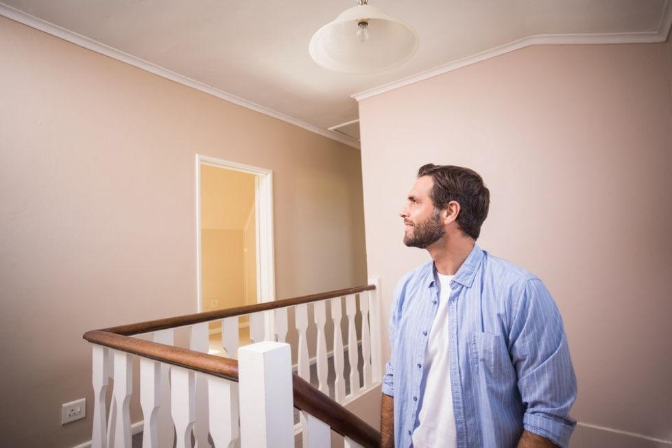 man walking up stairs in house