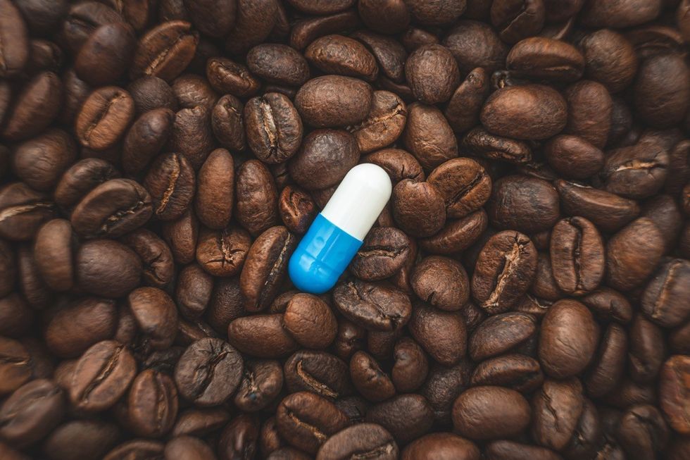 pill on the background of coffee beans.