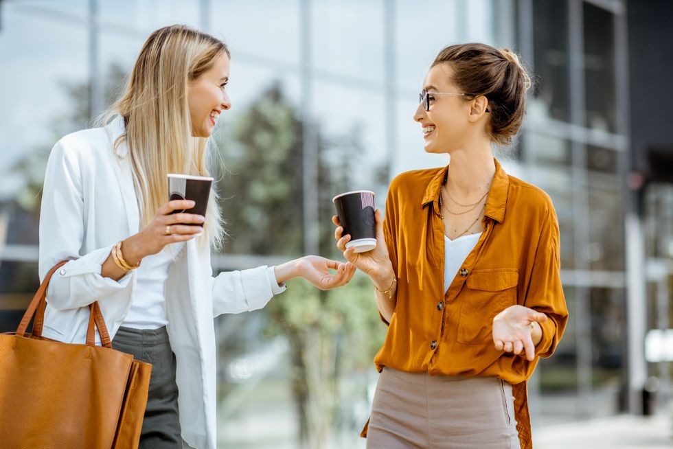 two women getting to know each other while drinking coffee