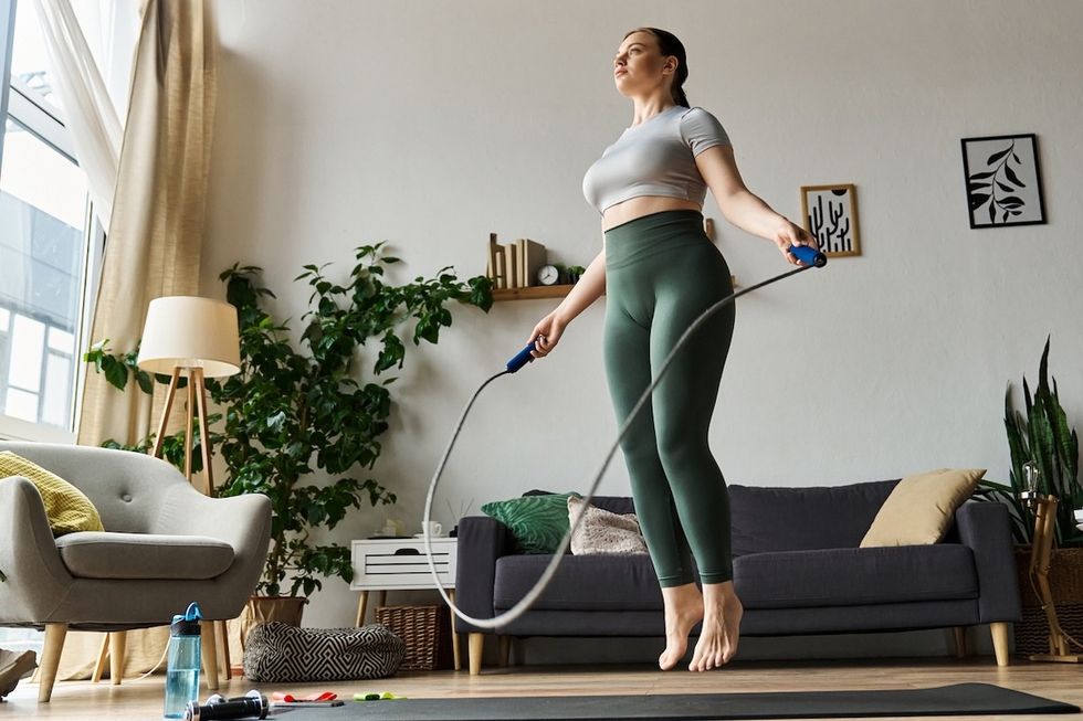 woman jumping rope in her living room