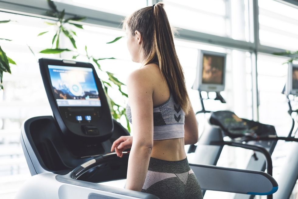 woman on a treadmill watching something on the screen