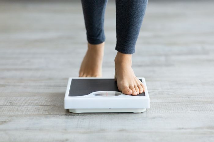 woman stepping on scale