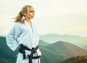 Beautiful black belt martial artist on a mountain top.