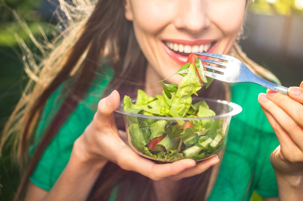 losing weight in your 40s woman eating salad
