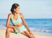 losing weight in your 40s woman stretching on a beach best body