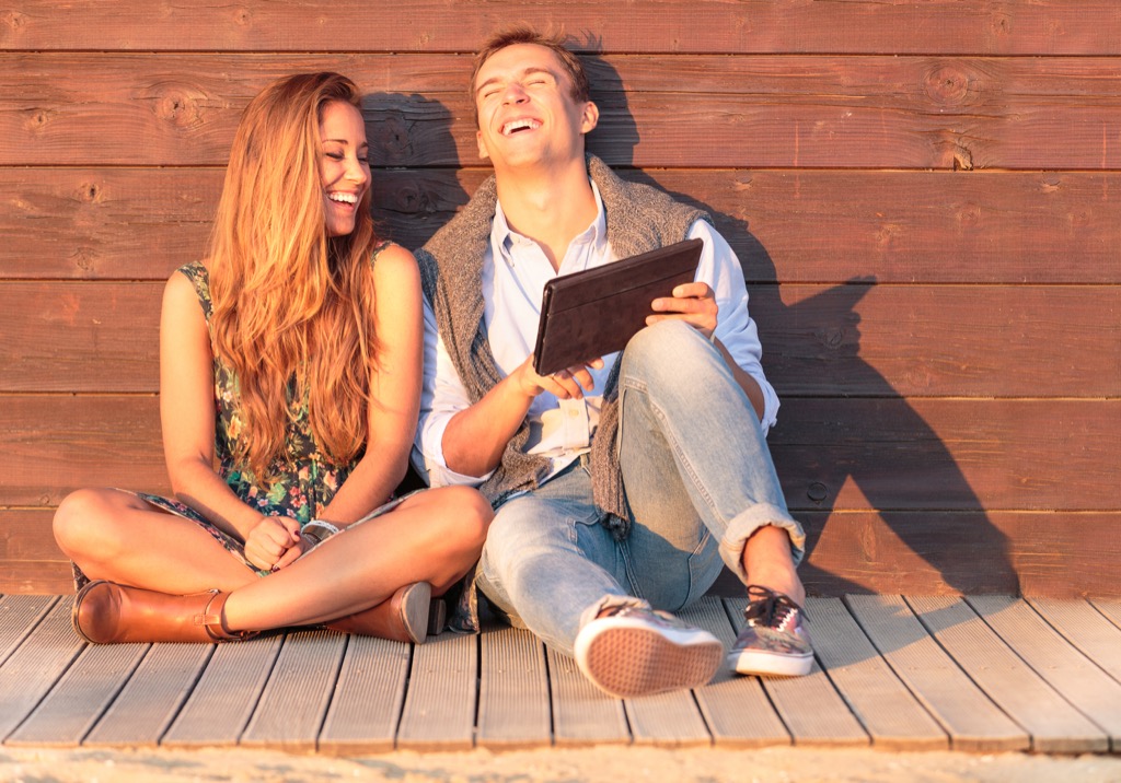 man and woman laughing with a tablet, things divorced people know