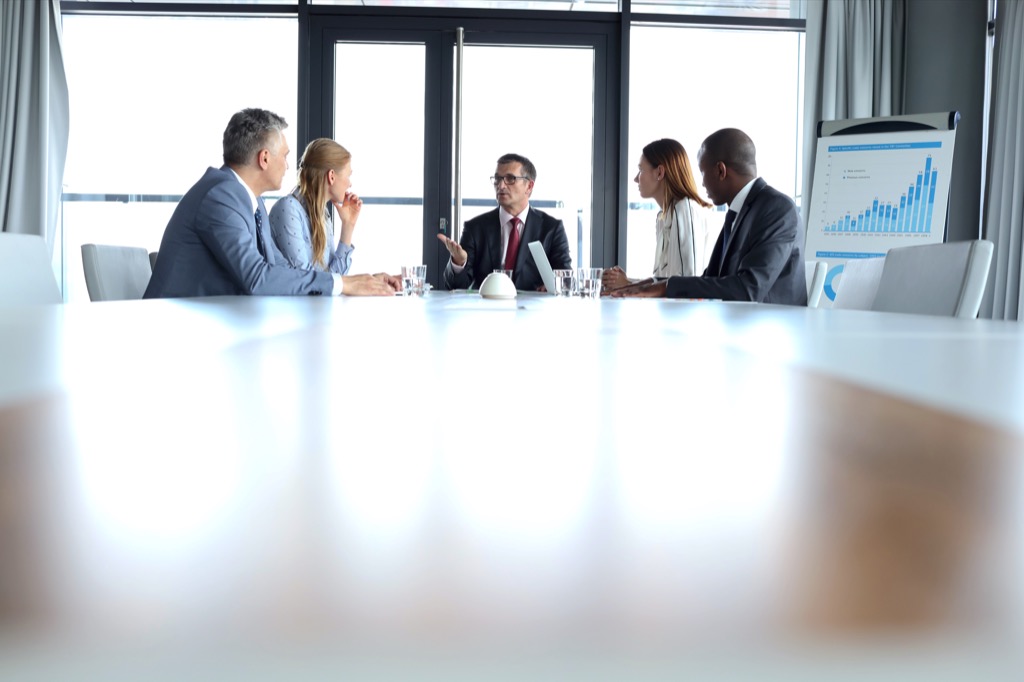 group of people at end of conference table during work meeting