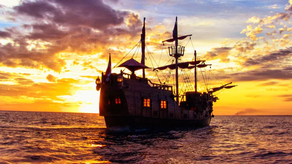 a pirate ship literally riding off into the horizon