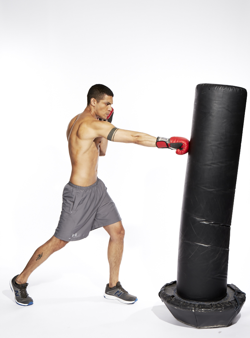 Man hitting the heavy bag, part of a great MMA training routine. 