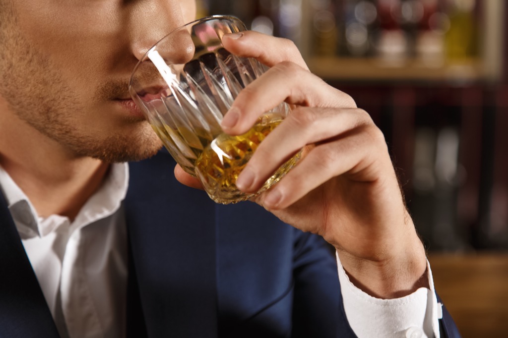 man drinking whiskey