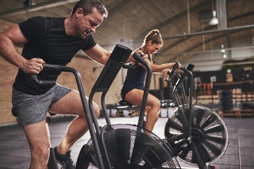 man and woman exercising cardio workouts for men over 40