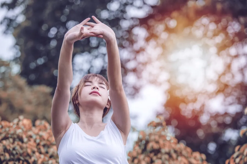 woman breathing and stretching, ways to feel amazing