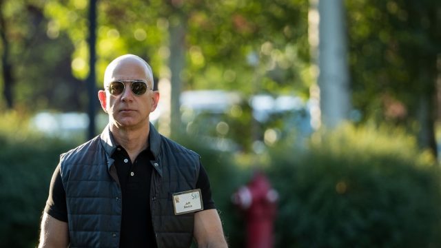 an extremely yolked jeff bezos wearing mission impossible sunglasses and a midtown uniform