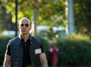 an extremely yolked jeff bezos wearing mission impossible sunglasses and a midtown uniform