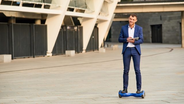 Man over 40 on a hoverboard