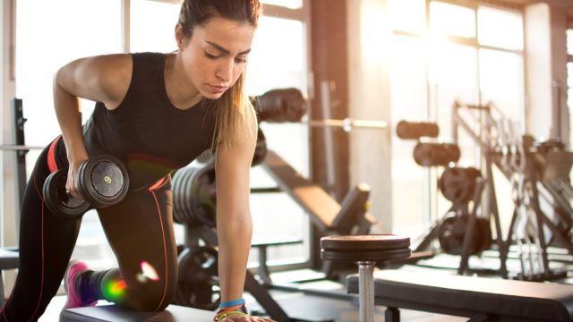 Gym woman arm raise workout routine