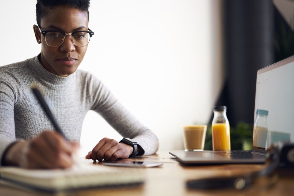 Woman Sitting Down Writing in a Notebook Social Etiquette Mistakes