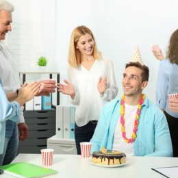 A man celebrating a birthday at work.