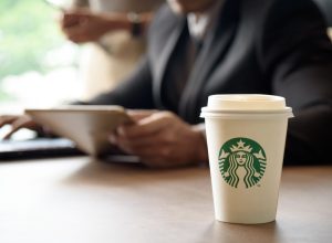 Starbucks coffee order and a man with a tablet.