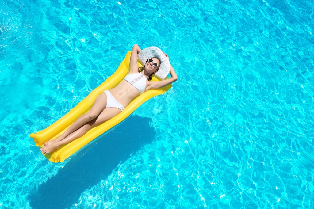 Beautiful single woman basking in a pool.