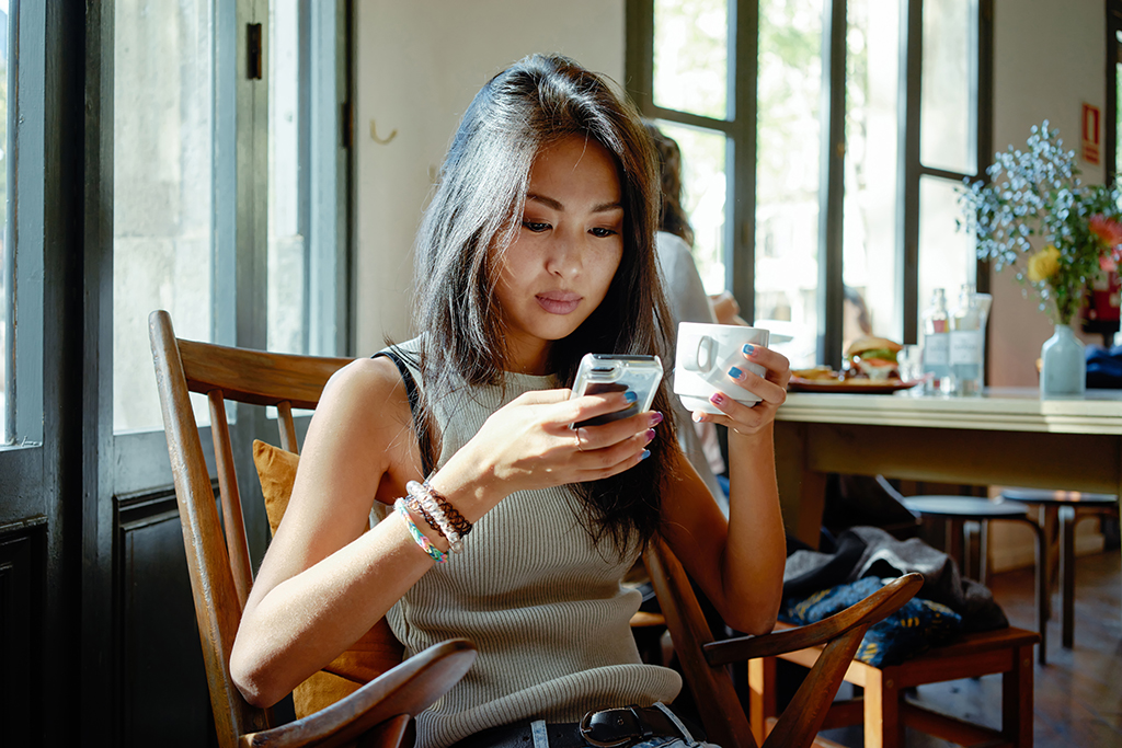 frustrated young woman, still single, coffee, phone, mistakes, dating app message
