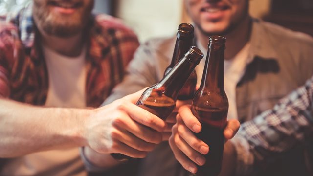 men doing a toast with beer bottles, relationship white lies