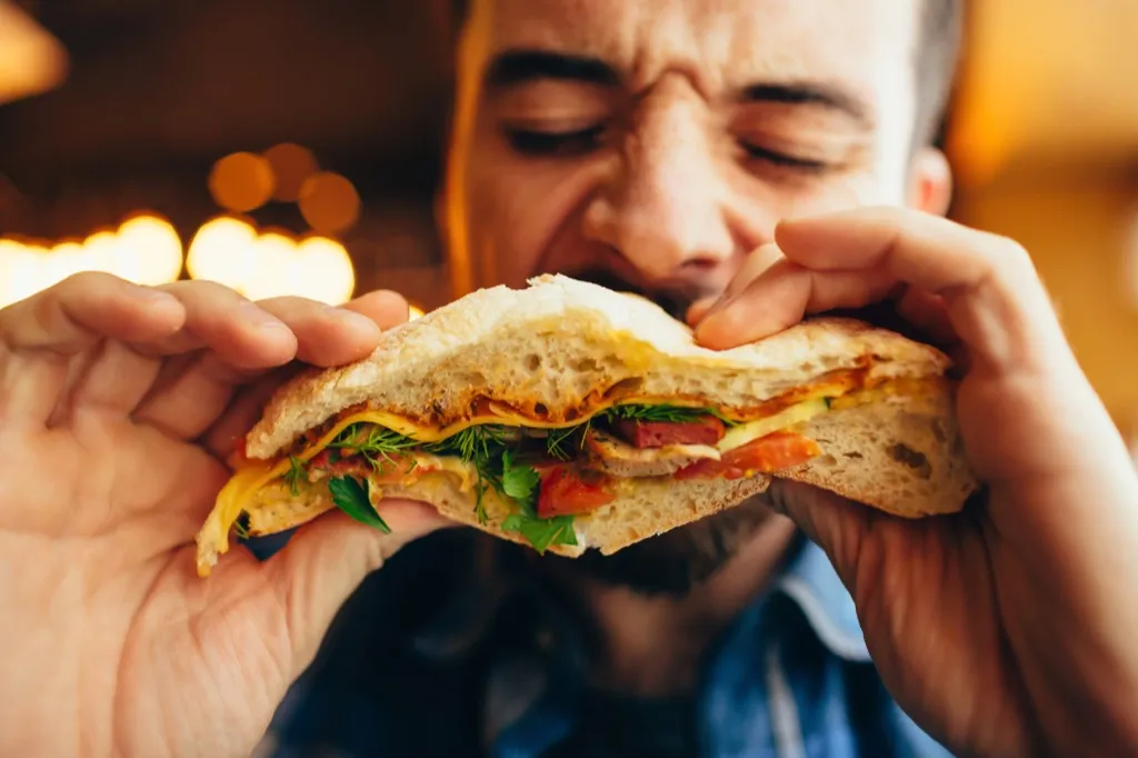 man eating burger after sex