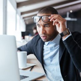 man looking at computer shocked