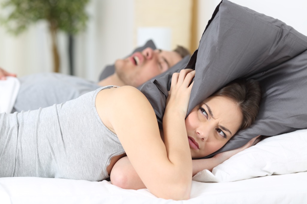 snoring couple in bed breathing problems