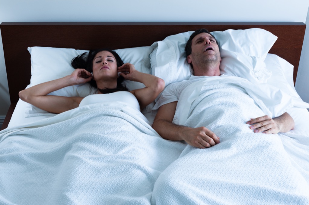 snoring couple in bed