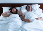 snoring couple in bed