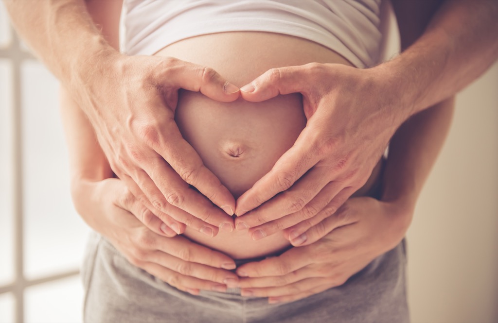 Parents holding pregnant stomach