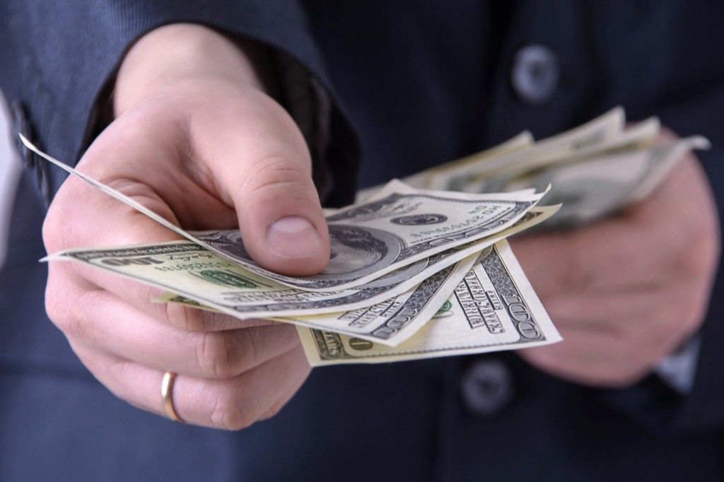 Man giving cash tip college professor secrets