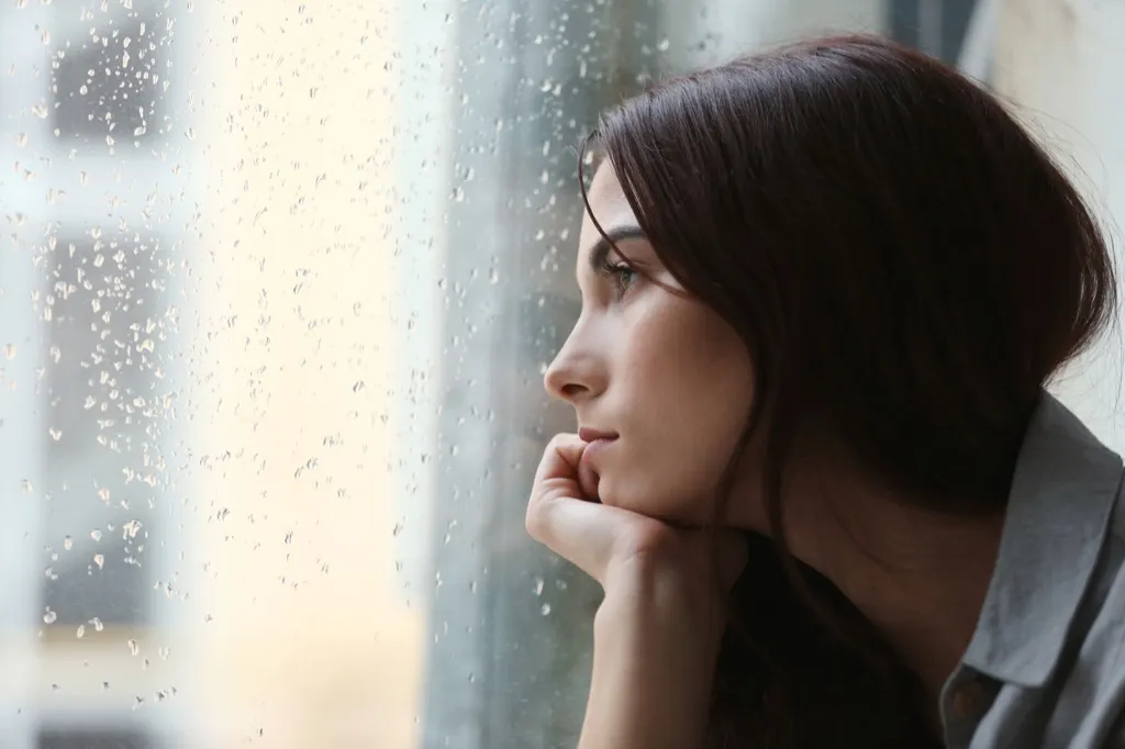 woman looking upset out rainy window, things divorced people know