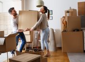 young couple moving boxes into new house, living together before marriage
