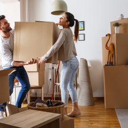 young couple moving boxes into new house, living together before marriage