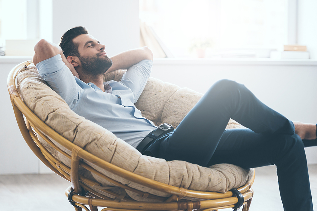 man relaxing in a chair - being single