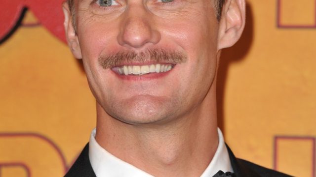 alexander skarsgard and his completely misguided facial hair smile stupidly on the emmy's red carpet